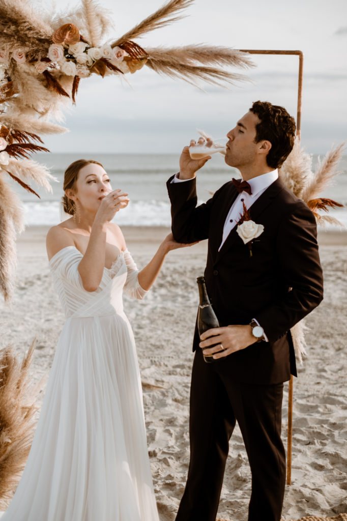 bride and groom drinking champange