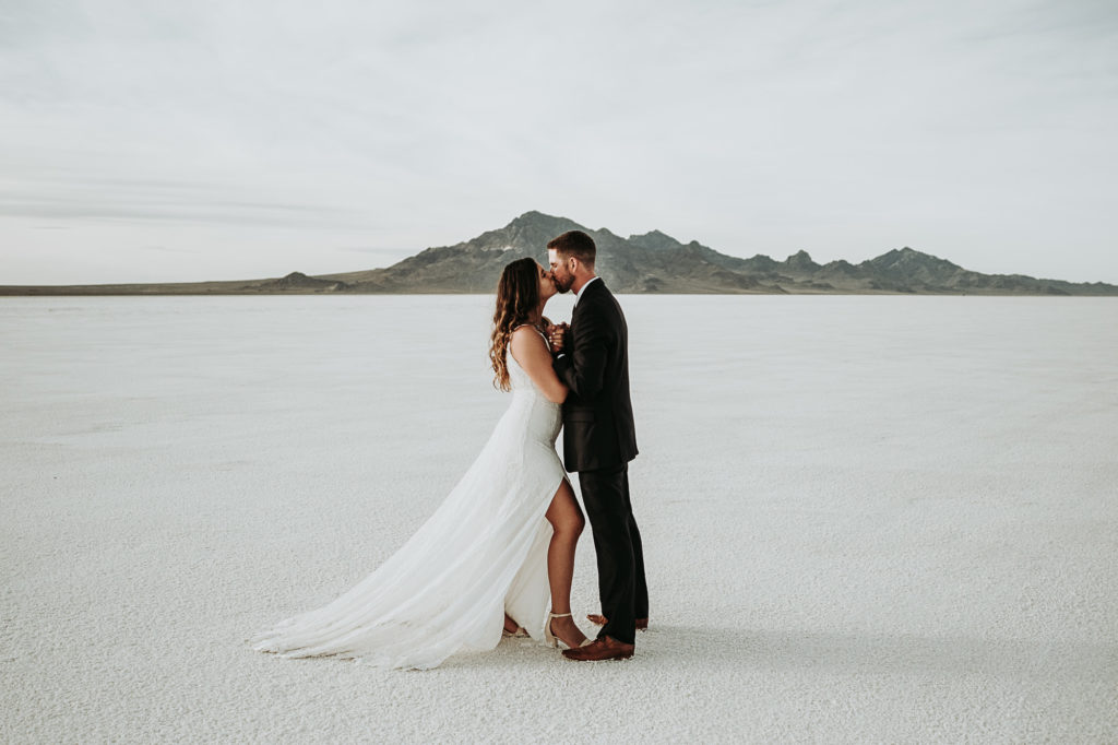 bride and groom kissing in salt flats