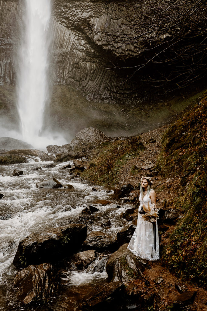 bride by waterfall with bouqet