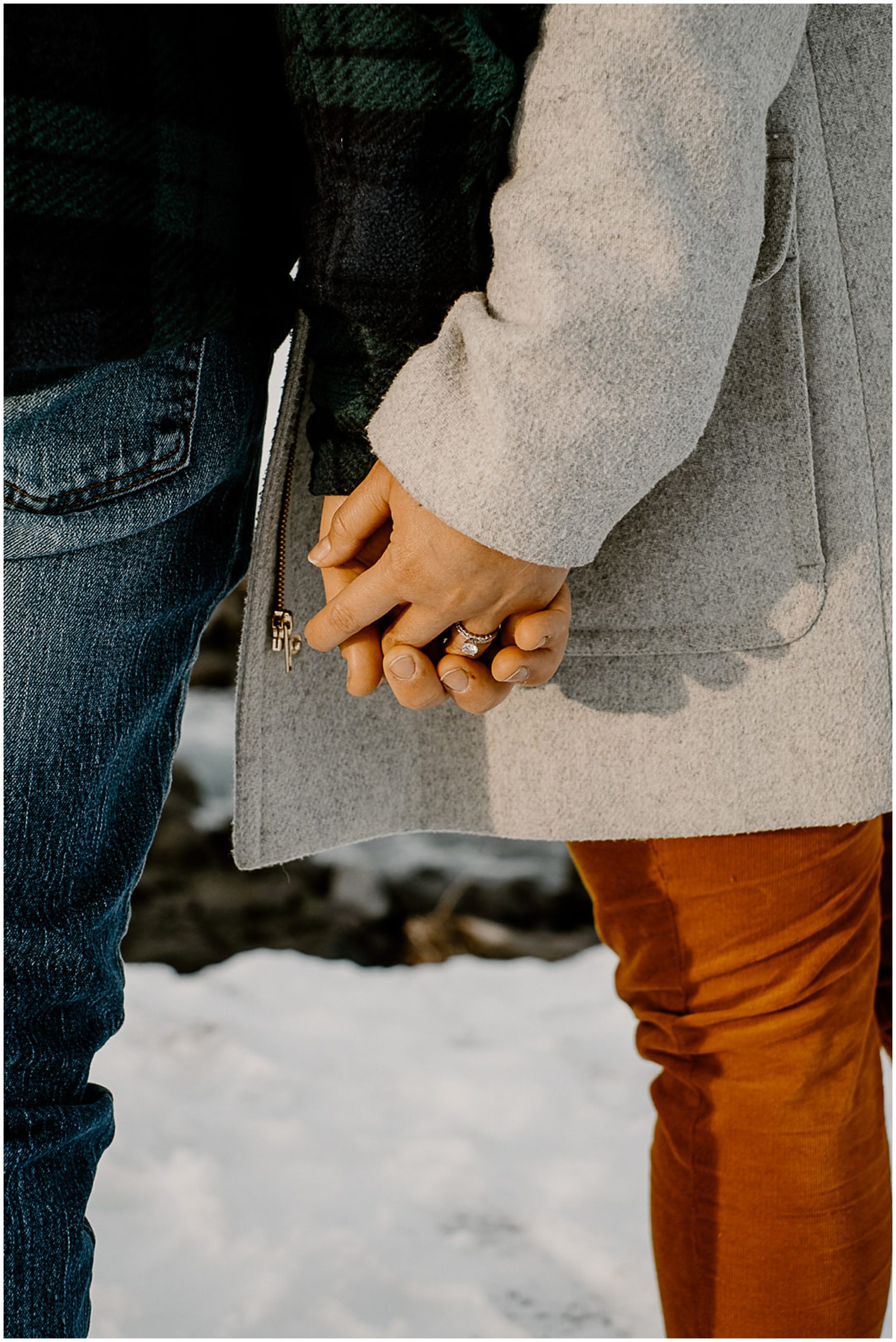 couple holding hands with wedding rings on
