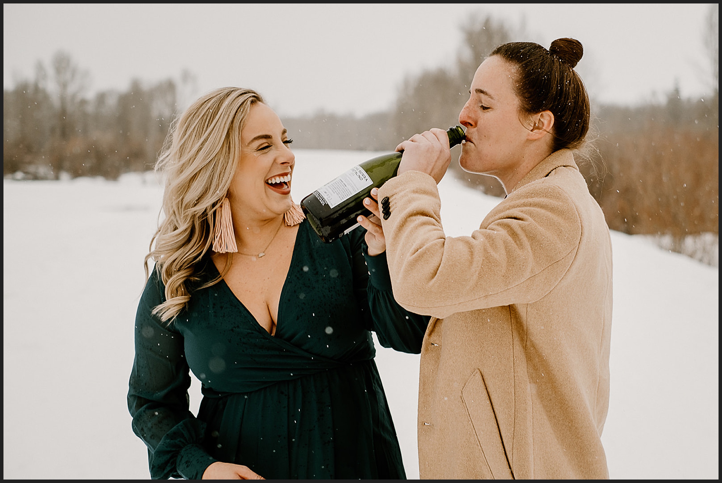couple drinking champagne in snow