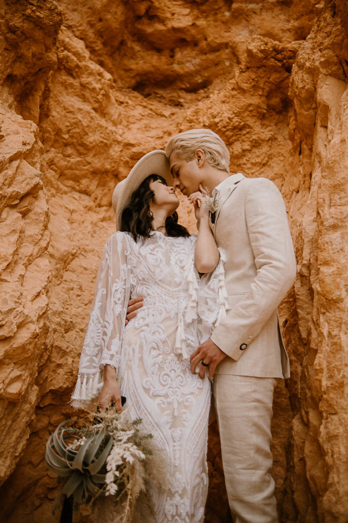 Man and women kissing during desert elopement