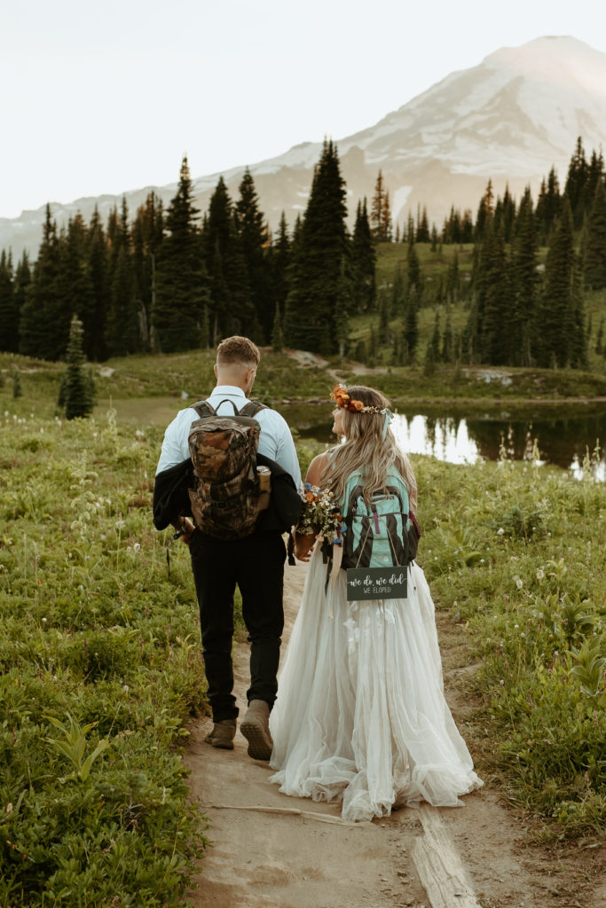 Man and women hiking through the mountains for elopement
