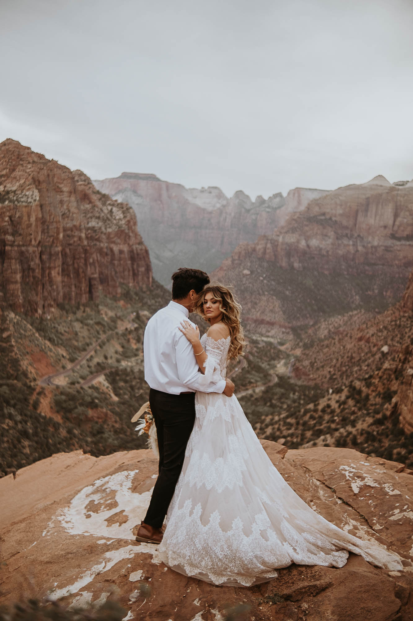 Man and women on top mountain in Zion during elopement