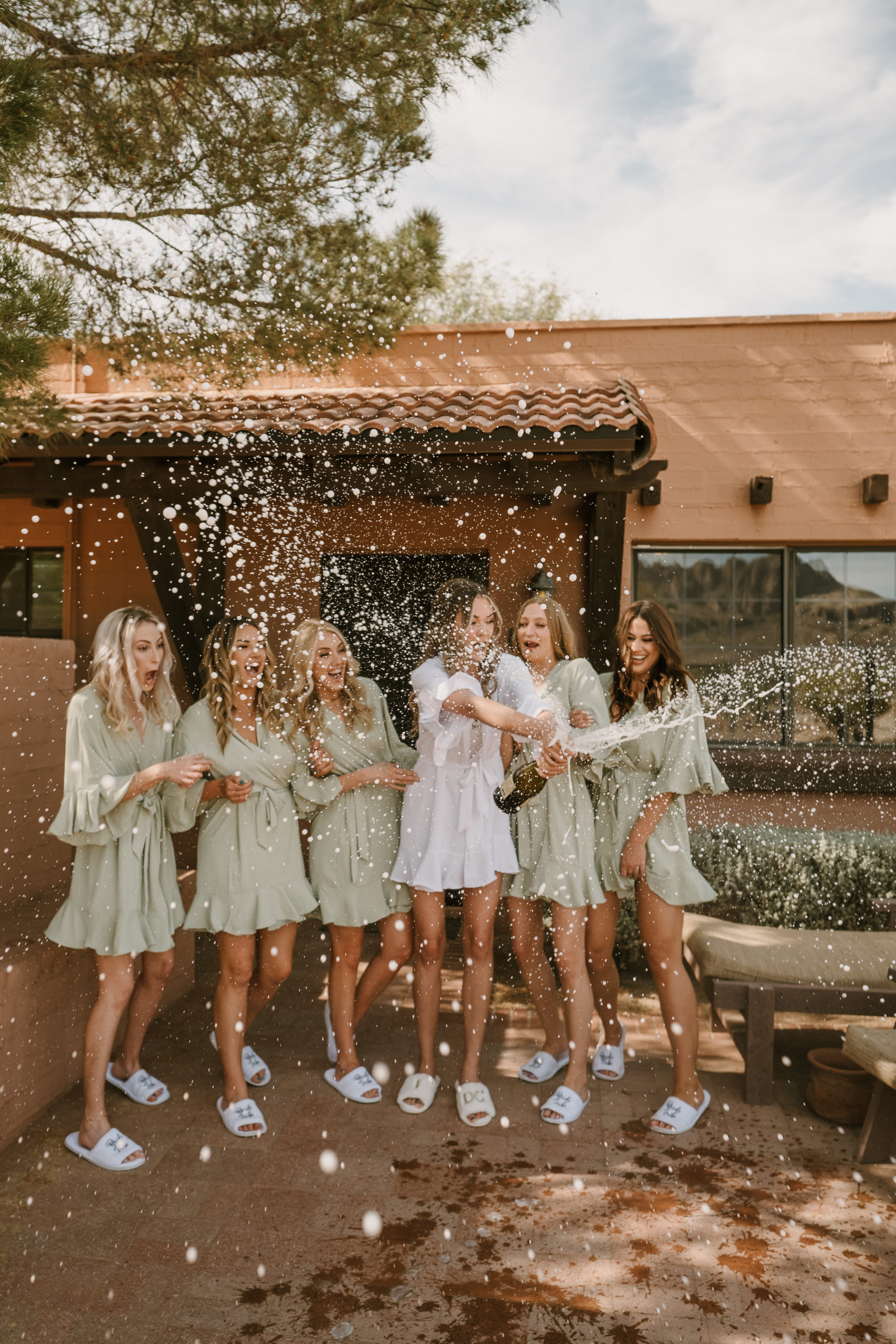 Bride Popping Champagne with Bridesmaides at Boho Tucson Weddingo