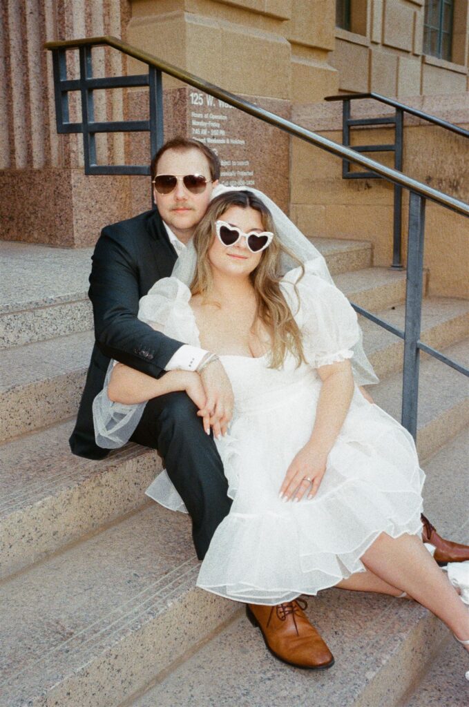 Bride and Groom sitting on courthouse stairs downtown Phoenix