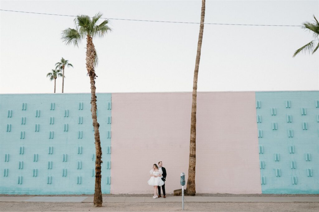 Bride and Groom in front of pink wall downtown Phoenix