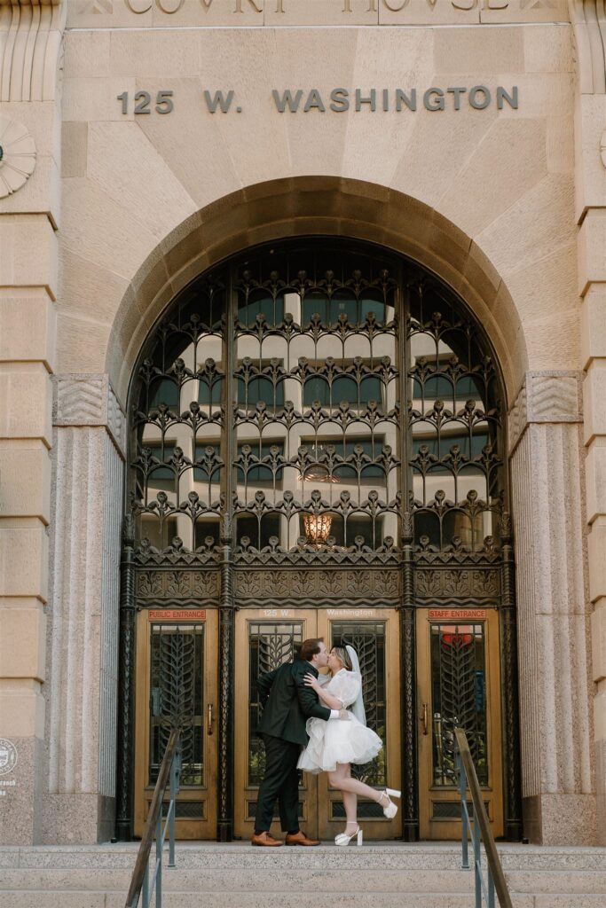 Bride and groom kissing infront of courthouse downtown Phoenix