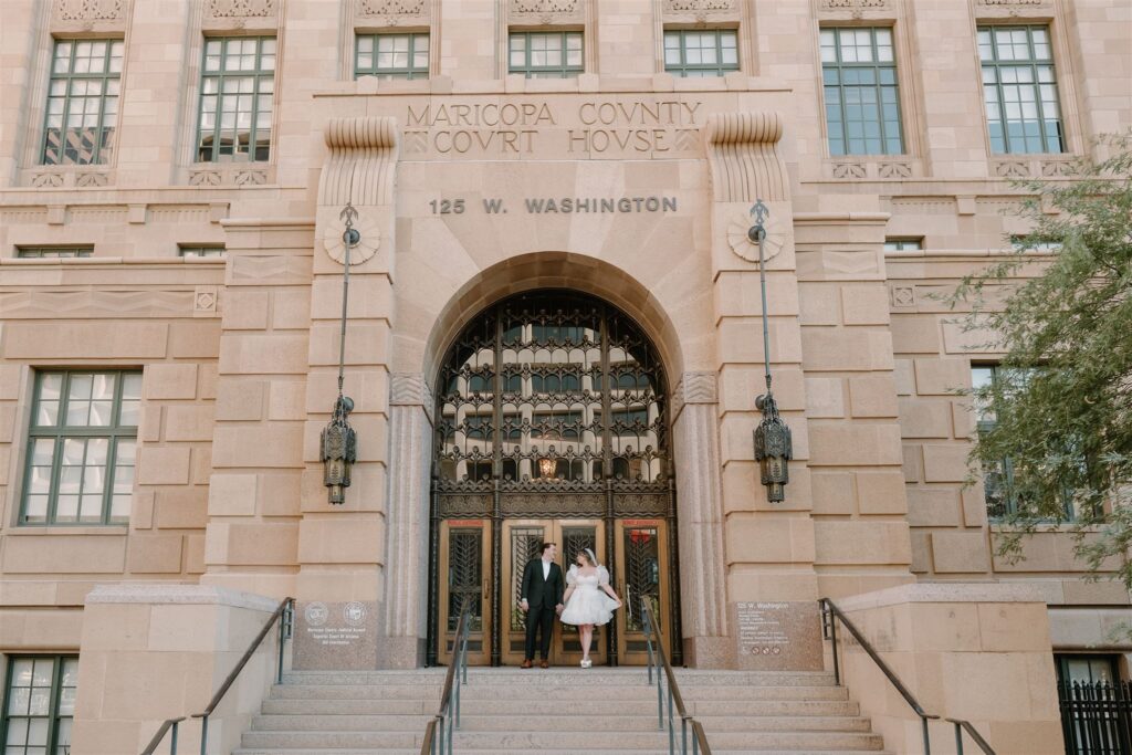 Bride and Groom holding hands outside of courthouse downtown Phoenix