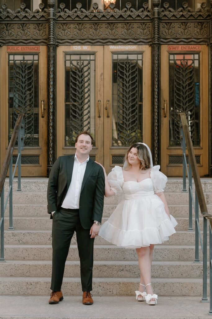 Bride resting hand on Grooms shoulder on courthouse steps