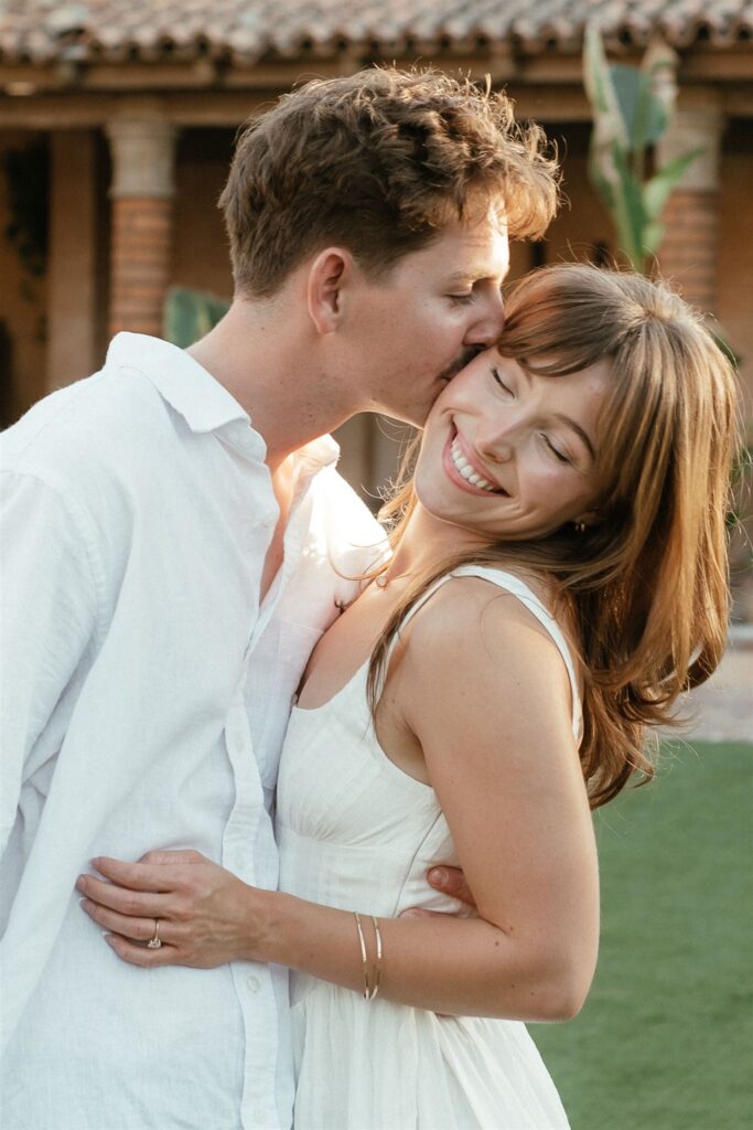 man kissing women on the cheek for engagement photos