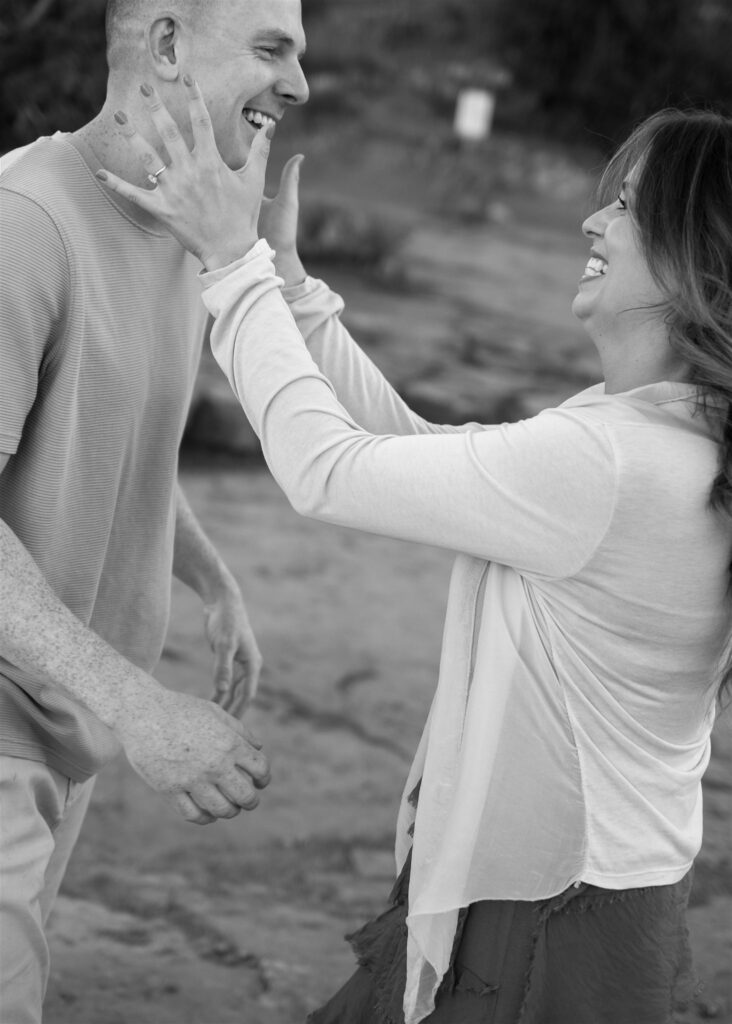 Cathedral Rock engagement photos in Sedona featuring a couple hiking and posing on red rock cliffs at sunset